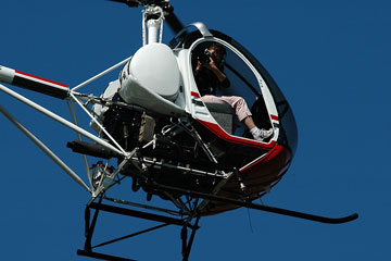an aerial photographer taking photos from a helicopter